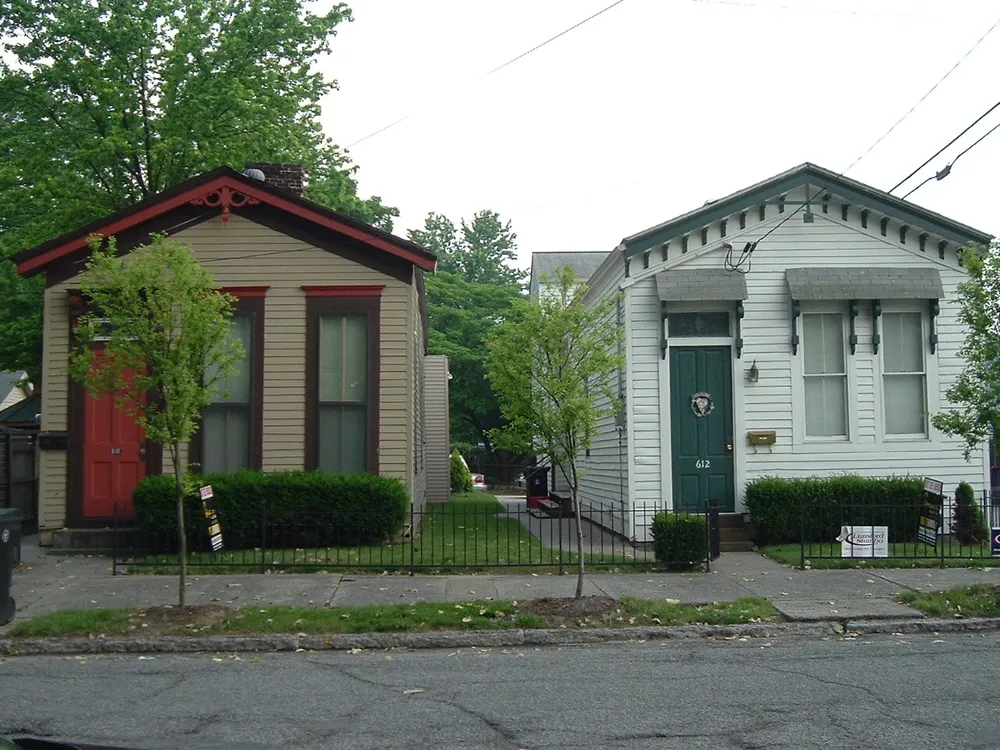 Two shotgun houses side by side on an older Louisville street