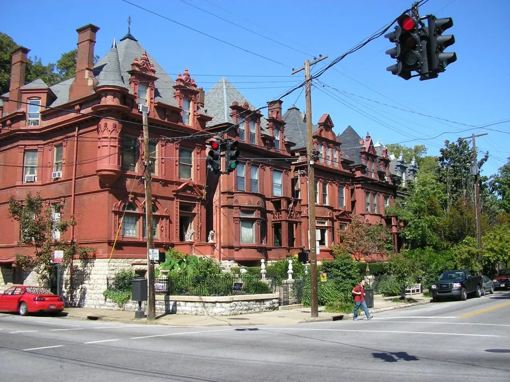 A large red brick Victorian house on a corner in Old Louisville